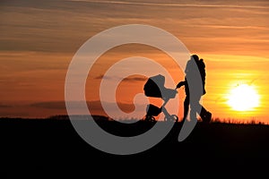 Happy romantic couple walking baby car sunset