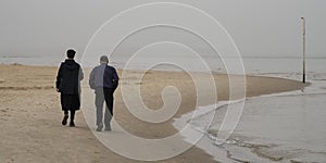 A Couple Walking on the Beach