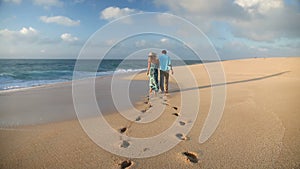 Couple Walking On Beach Enjoying Sunset Vacation On Romantic Honeymoon Travel