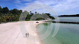 couple walking at the beach of Koh Kham Trat Thailand, aerial view of tropical island near Koh Mak