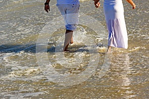 Couple walking on the beach sand