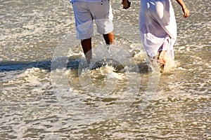 Couple walking on the beach sand