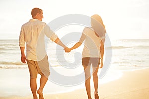 Couple Walking on the Beach at Sunset