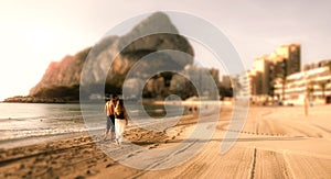 Couple walking on beach.