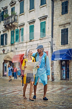 Couple walking through the city  and having fun on rainy day