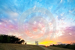 Couple walking into a colorful sunset