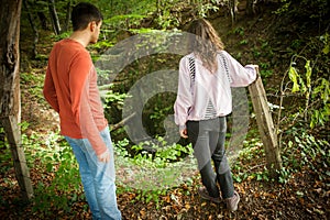 Couple walking in a deep forest on beautiful spring day