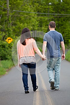 Couple Walking Down the Road Together