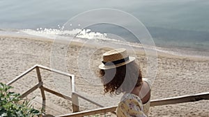 Couple walking down stairway on beautiful beach. Two lovers going to seashore.