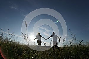 Couple walking through field