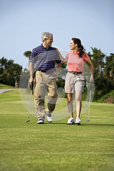 Couple walking on golf course