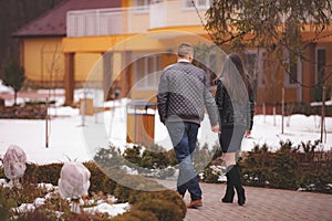 Couple walking hand in hand in a park