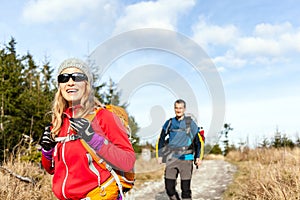 Couple walking and hiking on mountain trail