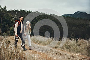 Couple walking, hiking and nature with travel, mountain and backpacking with wilderness and explore outdoor. People