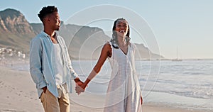 Couple, walking and holding hands on beach for love, romance and talking of date, vacation or valentines day. Young