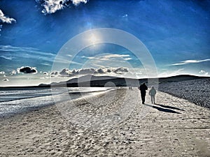 Couple walking on Keel Beach Achill Island county Mayo