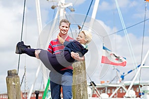 Couple walking at marina pier