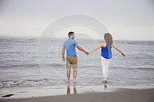 Couple walking into ocean