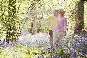 Couple walking outdoors pointing and smiling