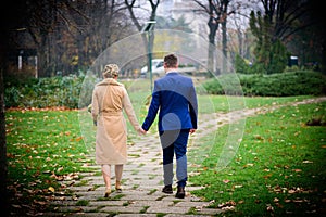 Couple walking in park holding hands