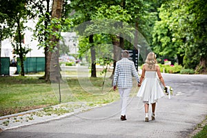 Couple walking in park holding hands