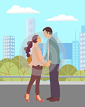 Couple walking in park. Young guy and girl holding hands, look into each other s eyes, romantic walk