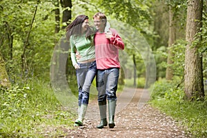 Couple walking on path arm in arm