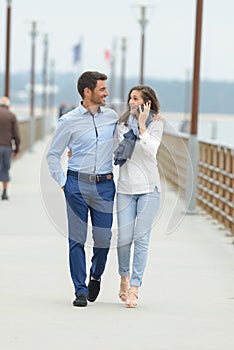 Couple walking on pier photo