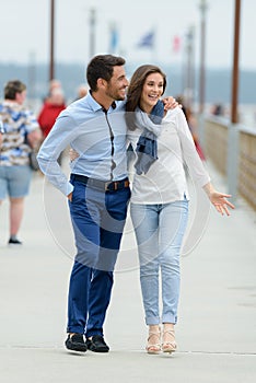 Couple walking on pier photo