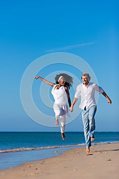 Couple walking and running on beach