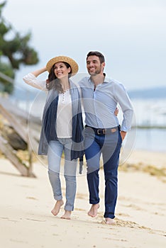 couple walking through sand dunes together photo