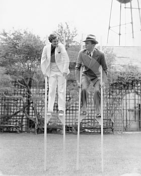 Couple walking on stilts