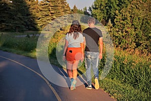 Couple walking in sunset on the road