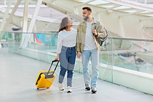 Couple walking together in modern airport