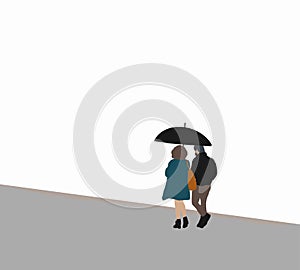 Couple walking together with an umbrella in rain walking on street.