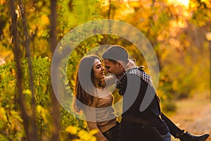 Couple walks in the park at sunset feeling loved and happy