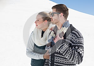 Couple in warm clothing on snow covered landscape