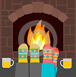 Couple in warm socks relaxing near fireplace