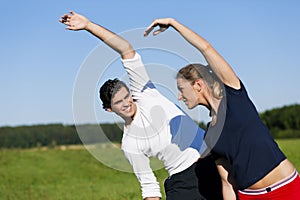 Couple warming up for exercise in summer