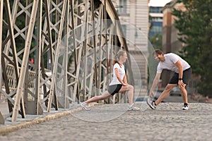 Couple warming up and stretching before jogging