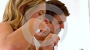 Couple washing their teeth with electronic toothbrush