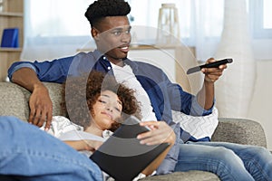couple watch tv on sofa