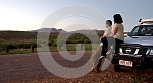 Couple Watching landscape from car in outback