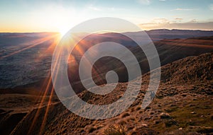 Couple watching sunrise on mountain summit