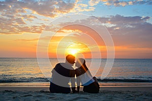 Couple watching the sunset on the beach