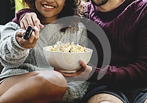 Couple watching TV having popcorn