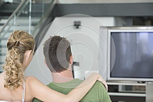 Couple Watching TV At Home