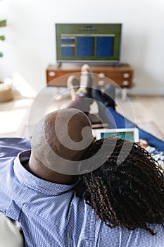 Couple watching TV at home together