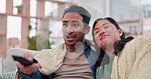 Couple, watching tv or a movie on a home sofa with a remote control for choice and relax. Asian man and a woman together
