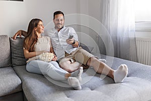 Couple watching TV and relaxing at home